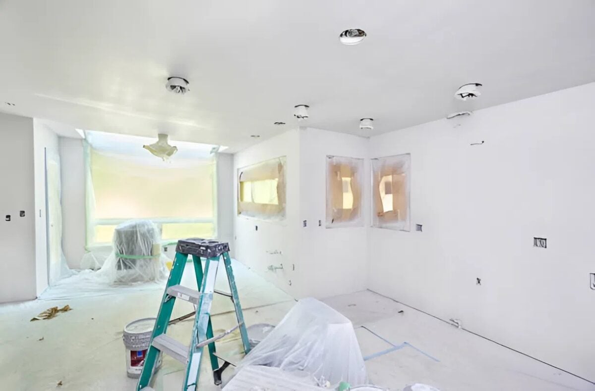 Preparing the room with protective coverings and ladder setup before painting by an interior painter in Plymouth, MN