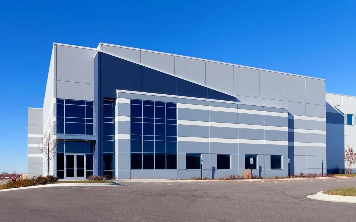 Office exterior with clean gray and blue panel siding by a painter in St. Cloud, MN