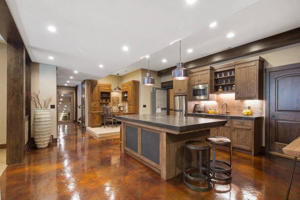 Modern kitchen with decorative epoxy concrete flooring with a glossy finish, by a house painter in St. Cloud, MN.
