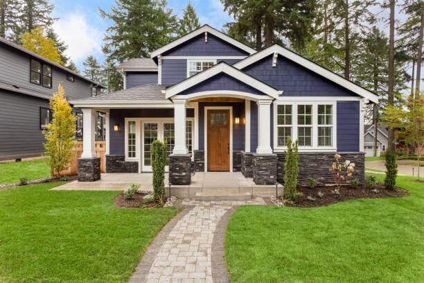 Modern blue-gray home exterior with freshly painted siding and crisp white trim by an exterior painter in Sartell, MN.