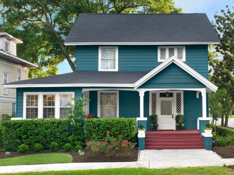 Dark teal exterior house paint with crisp white trim and modern contrast accents by an exterior painter in Sartell, MN