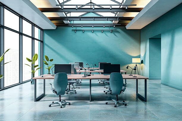 Office with blue accent walls, clean architectural lines, and premium interior paint finishes by a painting company in Maple Grove, MN.