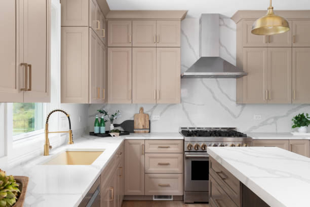 Modern kitchen with warm greige shaker cabinets with a smooth satin finish by an interior painter in St. Cloud, MN.
